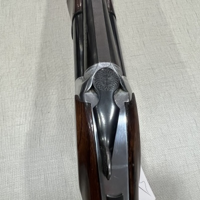 Espingarda de canos paralelos com madeira escura e metal gravado