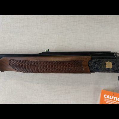 Espingarda em madeira com detalhes gravados e etiqueta de aviso laranja