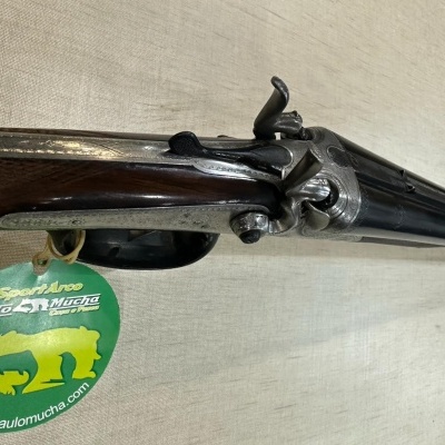 Arma de caça dupla com canos paralelos e etiqueta verde SportArmas Paulo e Múcha
