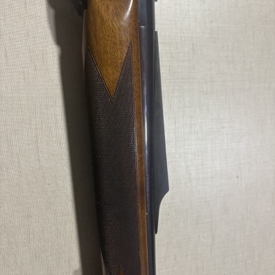 Espingarda de madeira com acabamento polido e detalhe texturizado
