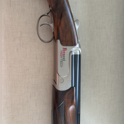 Espingarda over and under Perazzi High Tech com cabo em madeira castanha e corpo metálico prateado