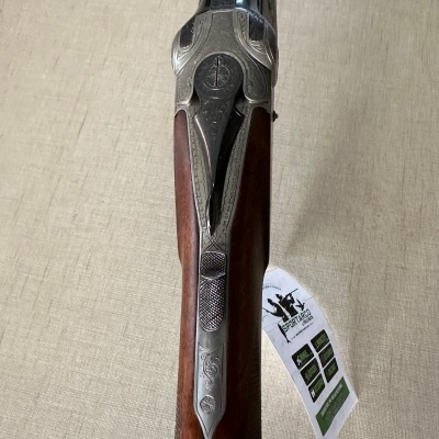 Espingarda de madeira com mecanismo de metal e etiqueta pendurada