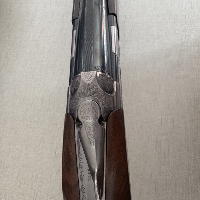 Espingarda com coronha em madeira castanha e canos de metal decorados com gravações