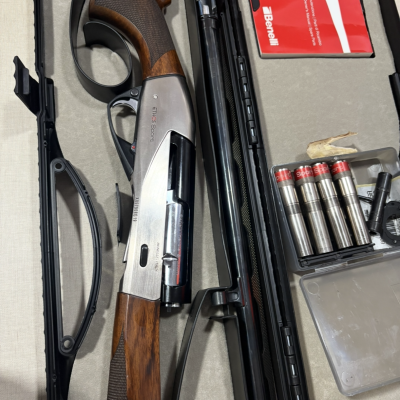 Espingarda de caça Benelli ETHOS Sport com acessórios e cartuchos, em estojo aberto.