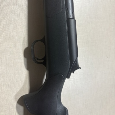 Parte de arma de fogo com empunhadura preta e cano cinza