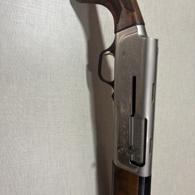 Espingarda com coronha de madeira e metal prateado gravado com texto A5