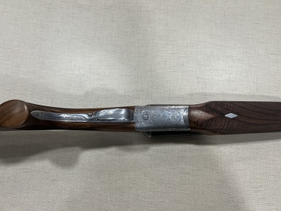 Colher de madeira com cabo e detalhe metálico em fundo bege