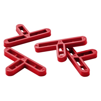 Espaçadores de azulejos vermelhos de plástico em forma de T sobre fundo branco