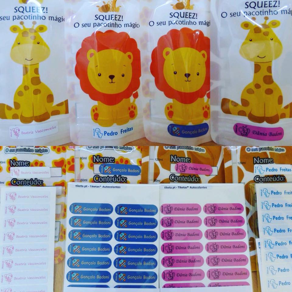 Pacotes de fraldas infantis com desenhos de girafa e leão e etiquetas adesivas coloridas com nomes