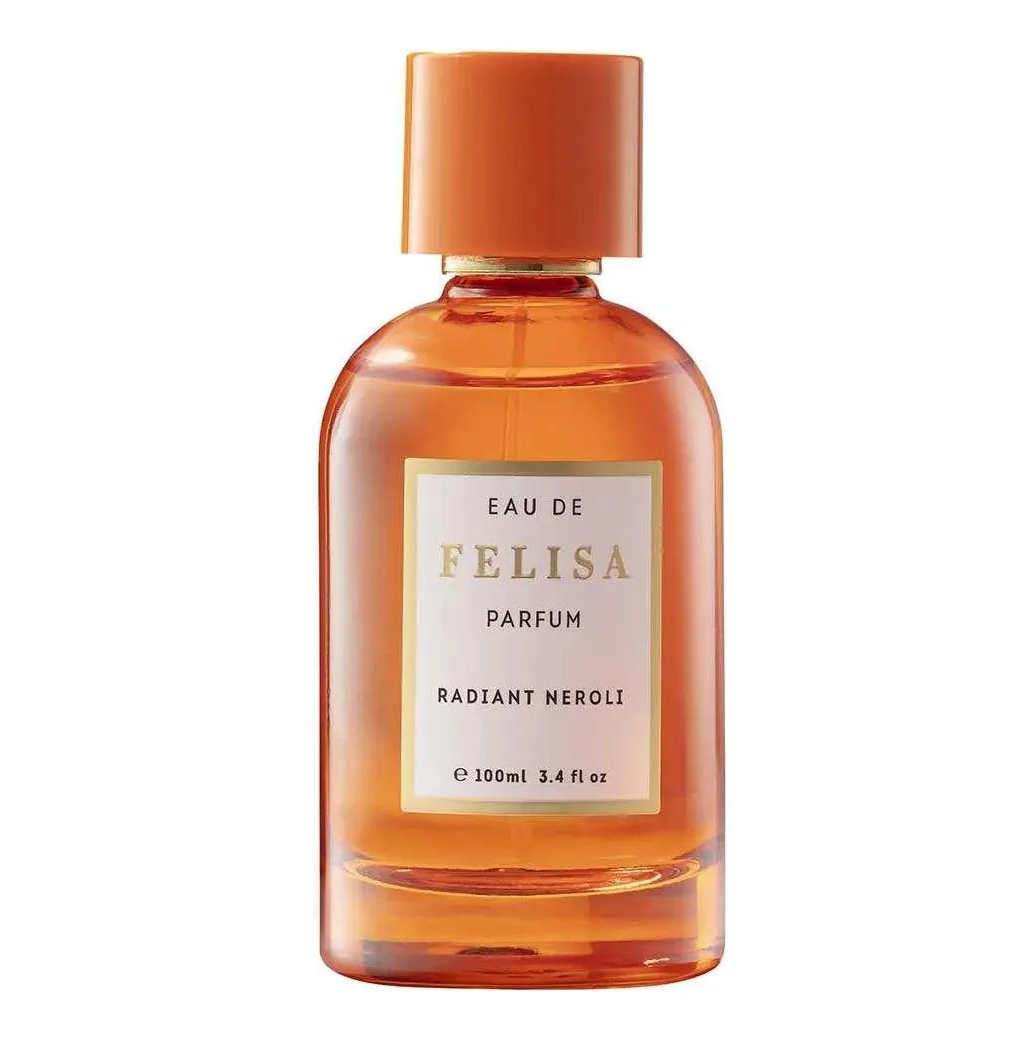 Frasco de perfume âmbar com tampa laranja e etiqueta branca com texto