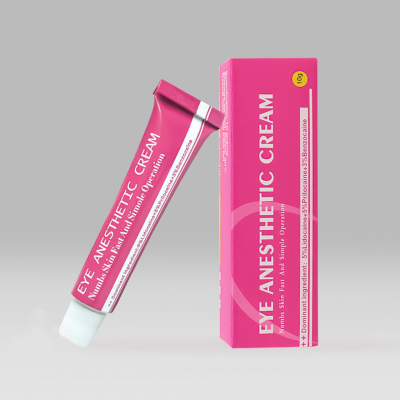 Embalaem e tubo rosa de creme anestésico para olhos com texto branco em fundo cinza claro