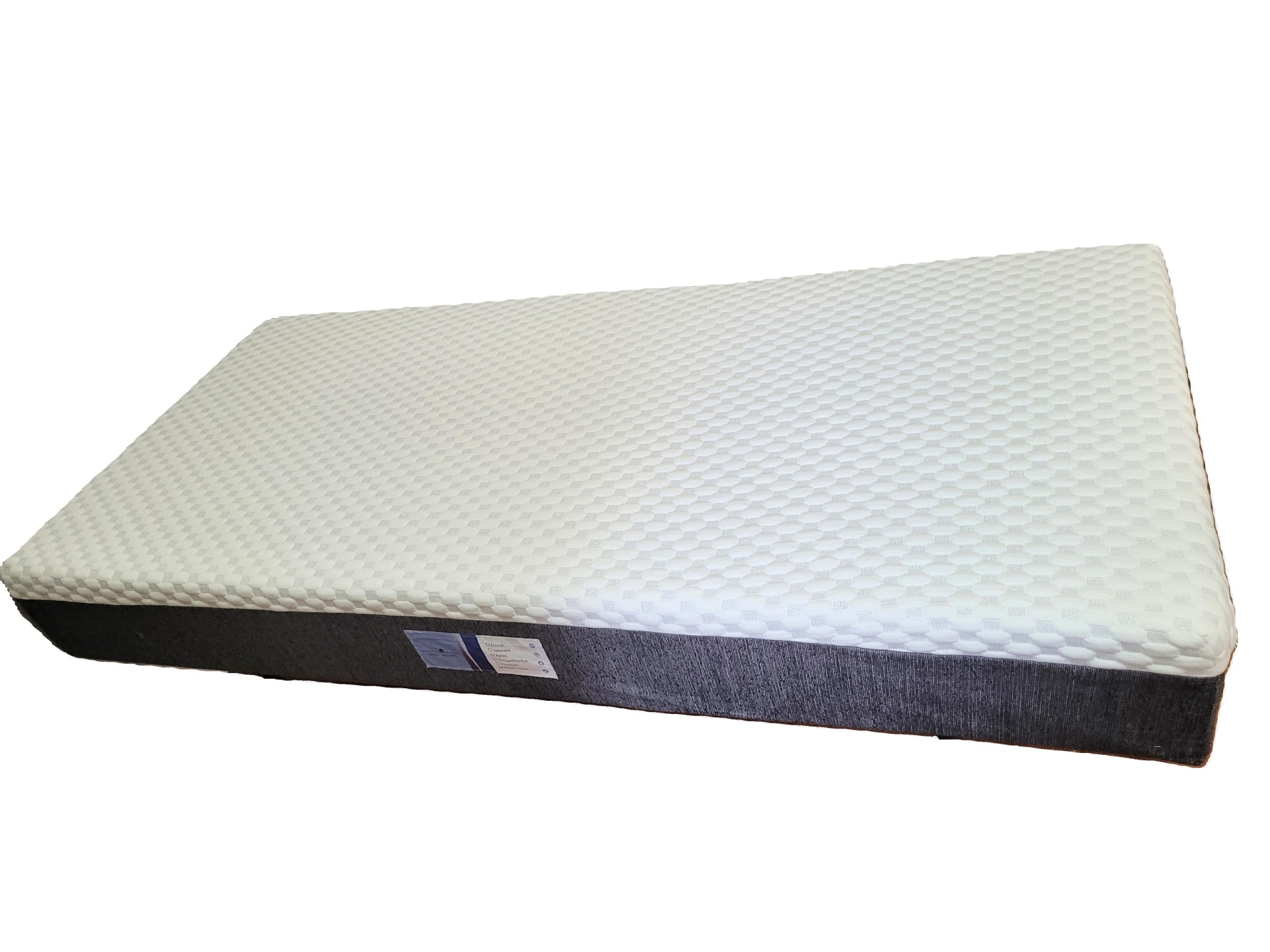Colchão branco com base cinzenta e etiqueta lateral
