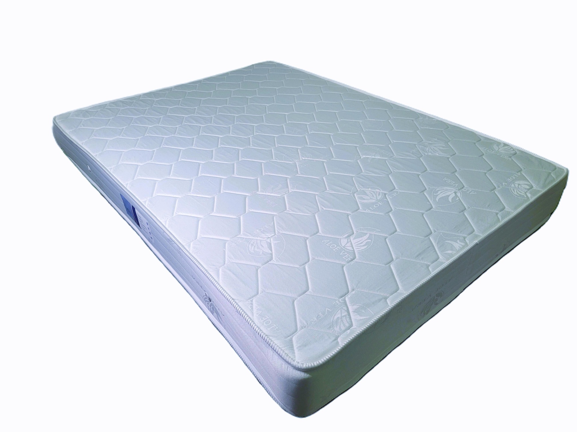 Colchão branco acolchoado com padrão hexagonal e texto ALOE VERA