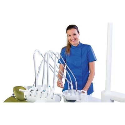 Dentista em bata azul com cadeira de dentista verde e equipamento odontológico branco