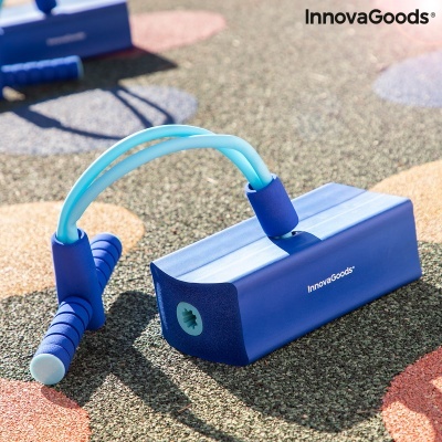 Equipamento de fitness azul InnovaGoods com cabos elásticos, sobre chão colorido.
