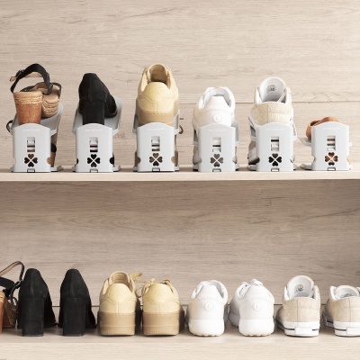 12 pares de sapatos organizados em prateleiras de madeira com organizadores brancos