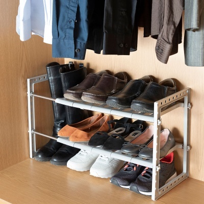 Estante metálica para sapatos com vários pares organizados dentro de um armário de madeira clara