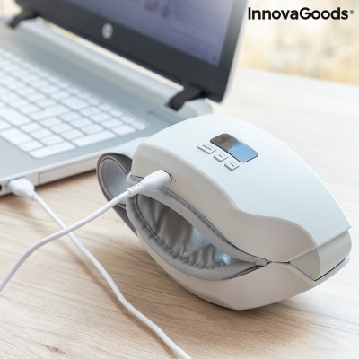 Dispositivo branco para massagem ocular com almofada cinza e ecrã digital ligado a portátil