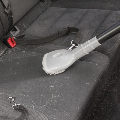 Escova de limpeza a limpar banco de carro com pêlos