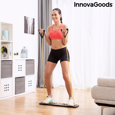 Plataforma de exercício preta com bandas elásticas amarelas numa sala interior