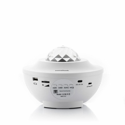 Dispositivo eletrónico branco com cúpula facetada transparente no topo e várias portas e botões