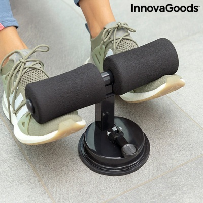 Suporte preto de fitness InnovaGoods com espuma e base de sucção no chão com sapatilhas verdes