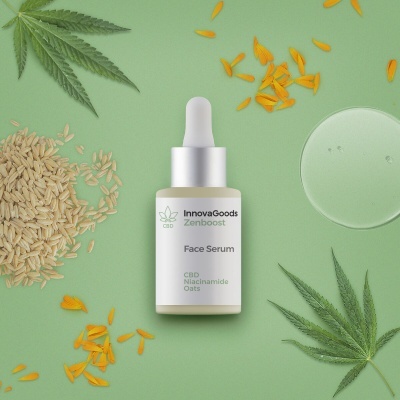 Frasco de sérum facial com conta-gotas e ingredientes naturais ao redor sobre fundo verde