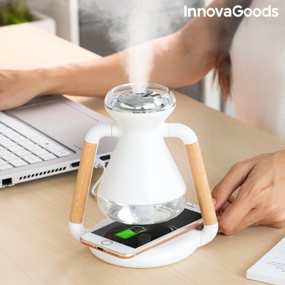 Humidificador branco com braços de madeira e carregador sem fios em mesa de madeira