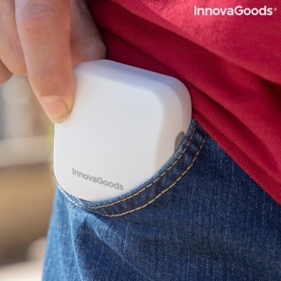 Dispositivo branco InnovaGoods a ser colocado no bolso de calças de ganga azuis.