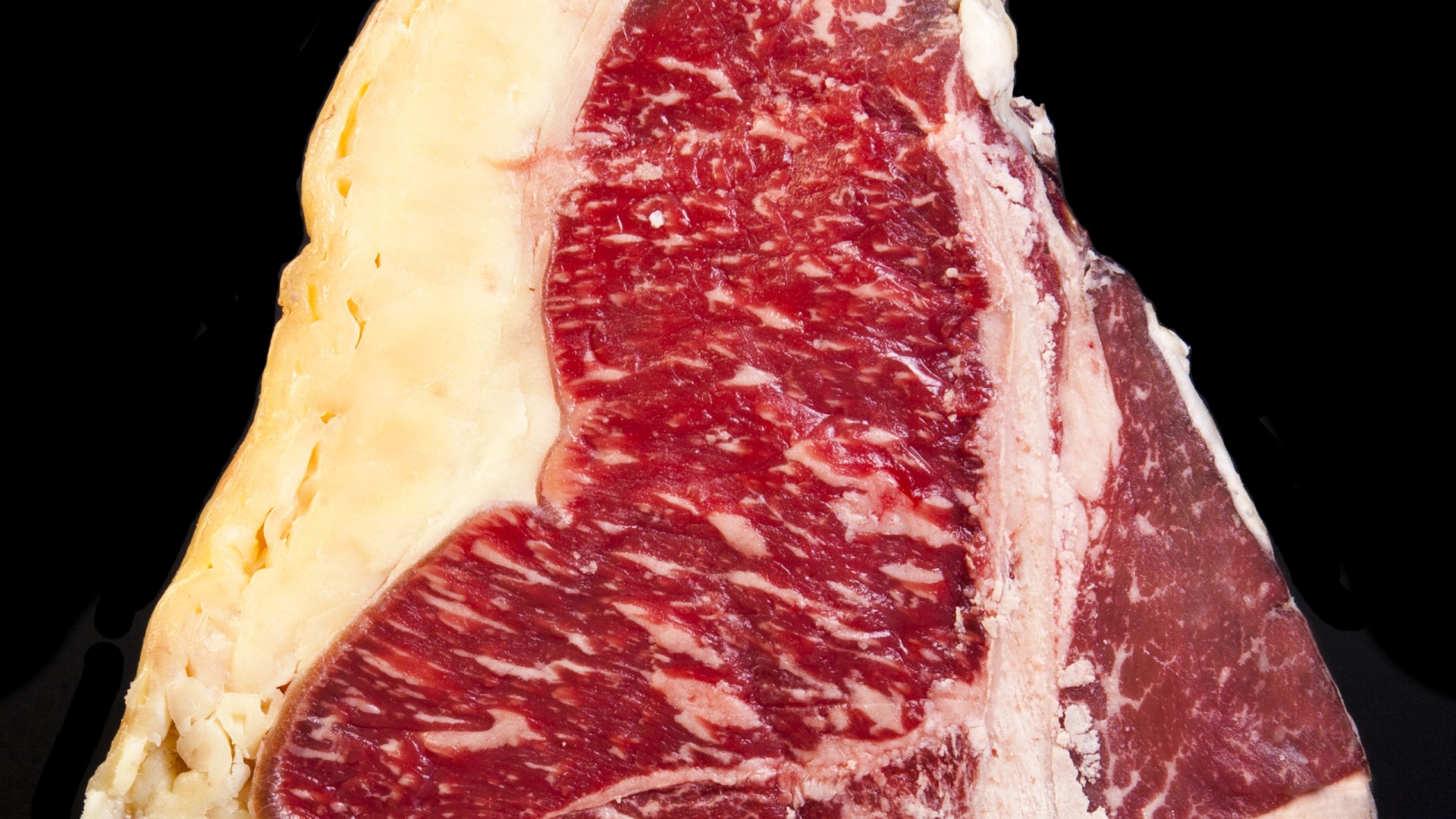 T-BONE Rubia Gallega Peça de carne com gordura e textura marmoreada em fundo preto