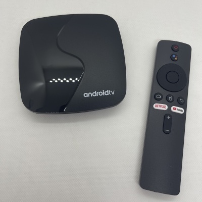 Caixa de streaming Android TV preta com telecomando preto com botões Netflix e Prime Video