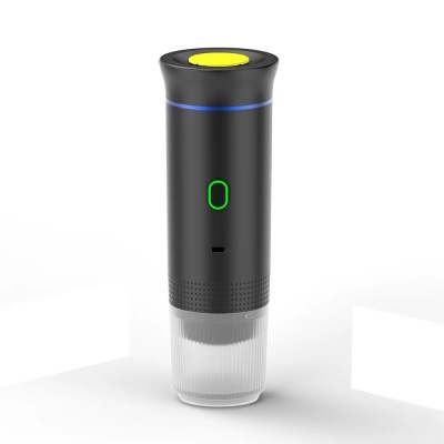 Dispositivo cilíndrico preto com botão verde e tampa transparente na base