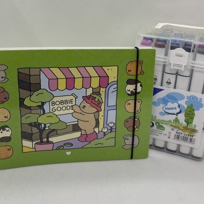 Caderno ilustrado verde com canetas marcadoras em estojo plástico