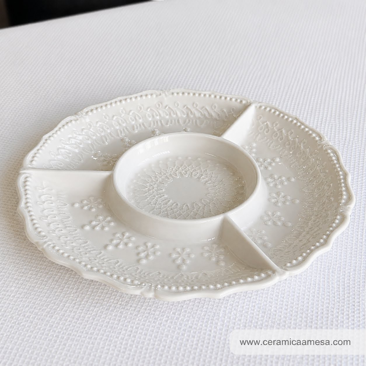 Coleção Grés Decorado Branco Prato de cerâmica branco com três compartimentos e padrões em relevo.