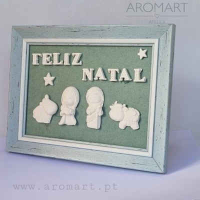 Quadro com frase Feliz Natal em letras brancas e figuras natalícias sobre fundo verde