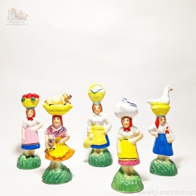 Cinco miniaturas coloridas de mulheres com objetos na cabeça em bases verdes