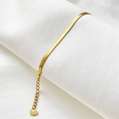 Pulseira dourada com coração em fundo branco