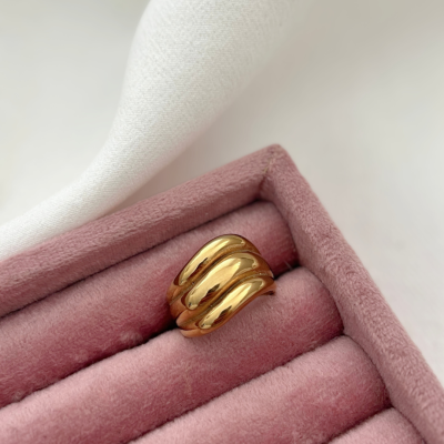 Anel dourado ondulado em caixa de veludo rosa