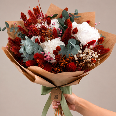 Buquê de flores secas em papel castanho com laço verde e etiqueta TERRACOTTA