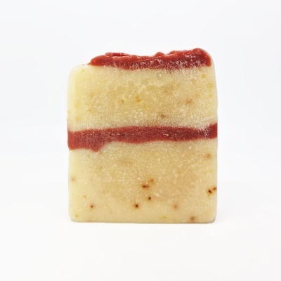 Sabonete retangular amarelo claro com faixas vermelhas e manchas castanhas