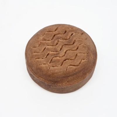 Bolo redondo castanho com padrão ondulado na superfície