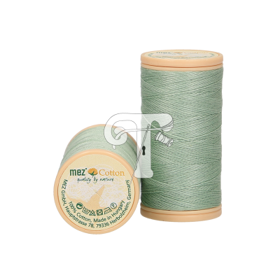 Rolos de linha verde claro de algodão com tampa bege e texto da marca MES Cotton.