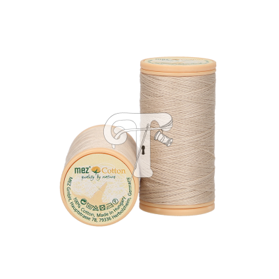 Dois carretéis de linha de algodão bege claro, um em pé e outro deitado mostrando o rótulo