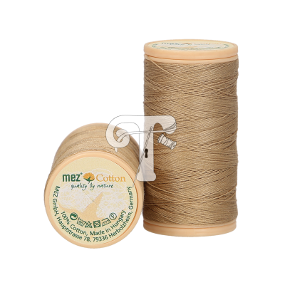Dois carretéis de linha bege com etiquetas 'mez Cotton quality by nature'