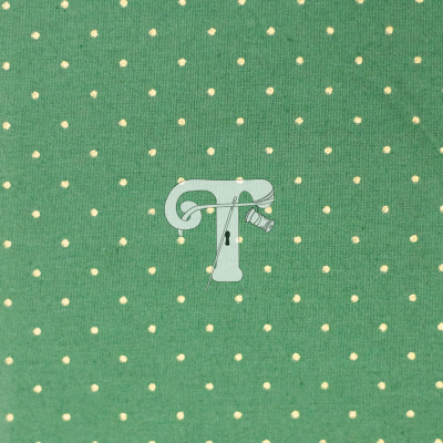 tecido verde com pontos brancos e logo estilizado com letra T e carretel
