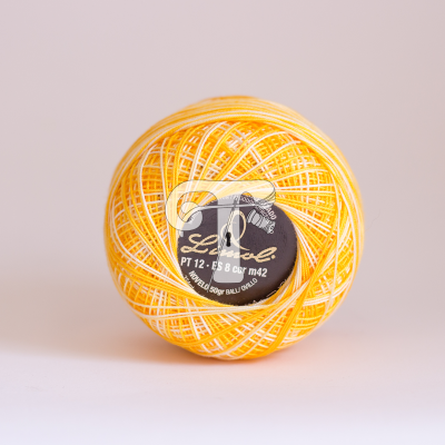 Rolo de linha de algodão amarelo e branco com etiqueta preta no centro