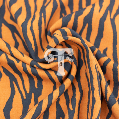 tecido com padrão de listras de tigre em laranja e preto