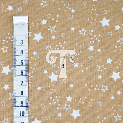 Tecido castanho com estrelas brancas e fita métrica