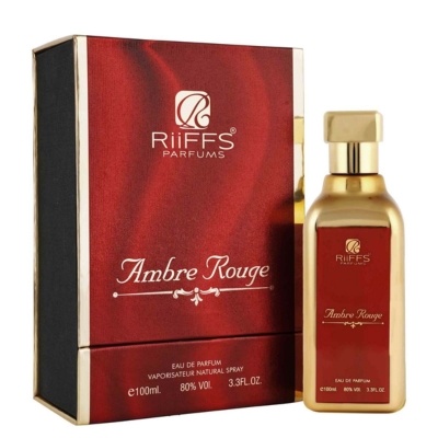 Frasco dourado de perfume Ambre Rouge ao lado da caixa vermelha e preta