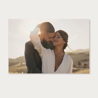 Casal abraçado ao pôr do sol em paisagem campestre